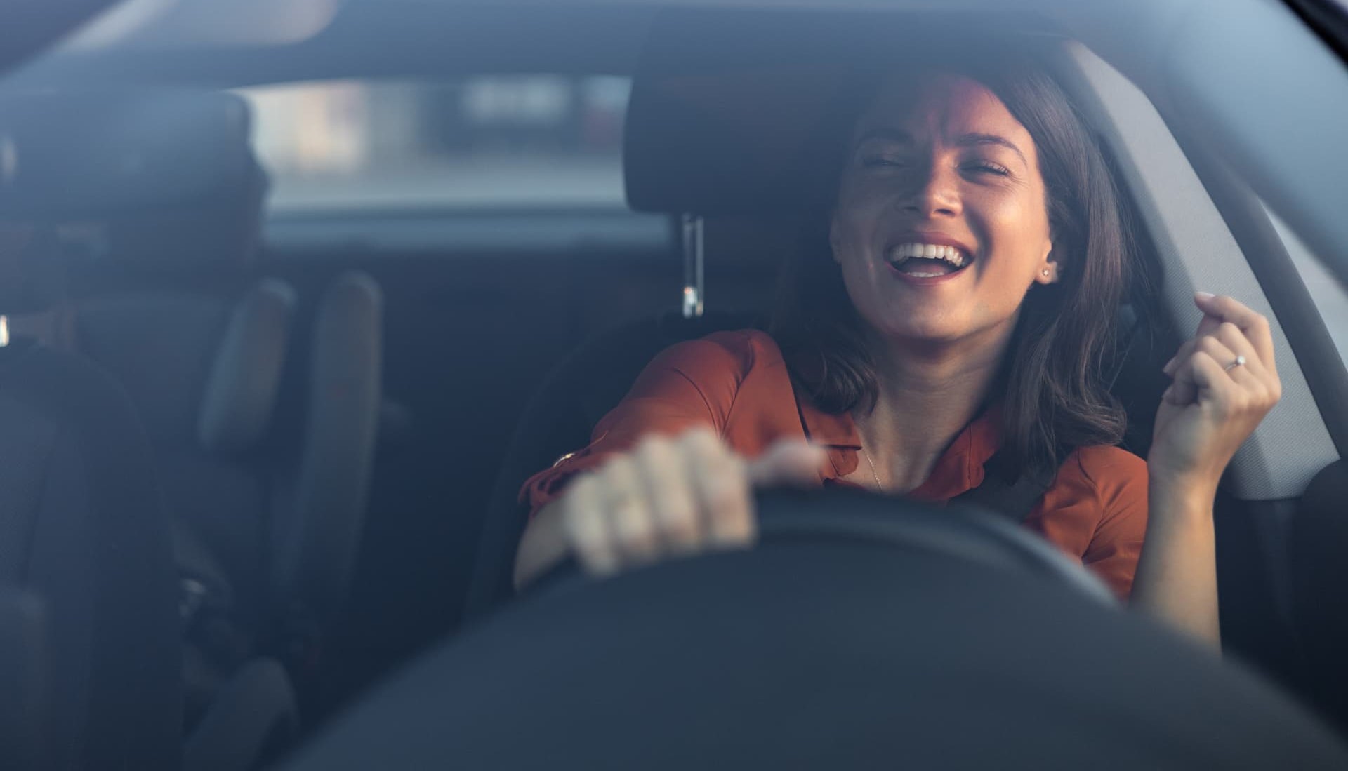 Women driving her new car after buying it with an auto loan with 90 days free from ECCU