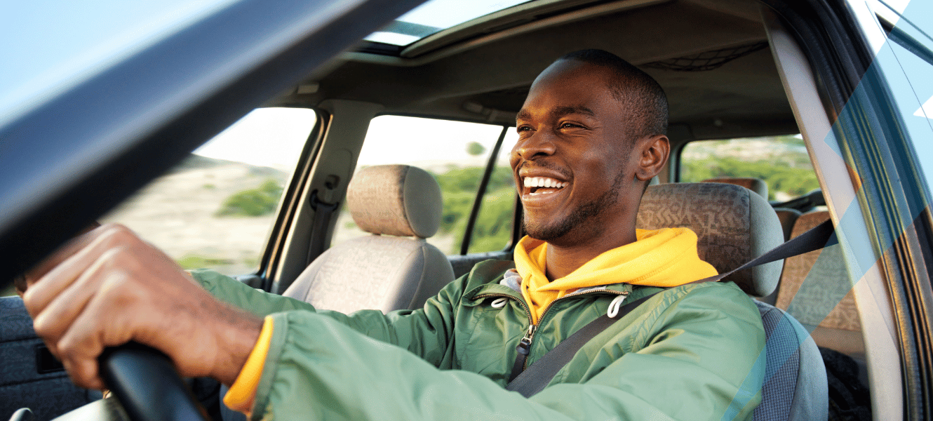 Man smiling in car