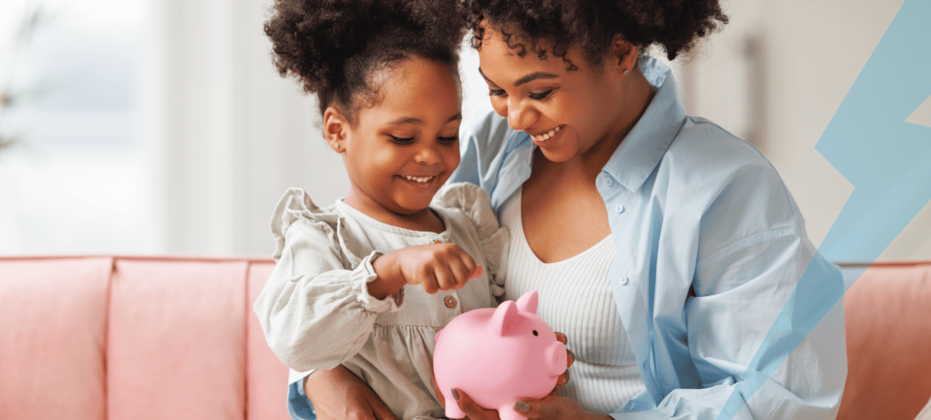 Mom holding daughter with piggy bank